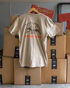 kuma merch, showing a heather grey american apparel t-shirt with a navy kuma bear head on the front left breast