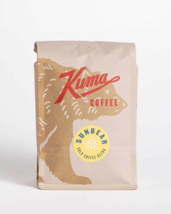 Kuma Coffee Craft coffee bag compostable coffee, Sun Bear Iced Coffee blend , with a coffee bear logo at the bottom. Iced coffee blend sticker that writes: A blend of east African and south american coffees made to shine when served iced. Tasting notes of chocolate, berries and grape