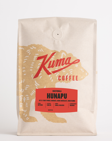 craft bag of bulk specialty coffee, kuma coffee logo with coffee bear wrapped around the front of the bag, side view of biotre biodegradable Guatemala Hunapu